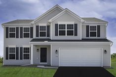 a two story house with white siding and black shutters