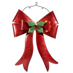 a red christmas bow with lights hanging from it's side on a white background