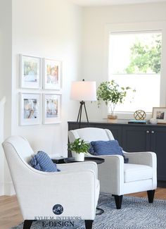 a living room with two white chairs and a blue rug