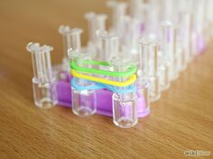 several different colored tubes are lined up on a table with one tube in the middle