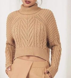 a woman wearing a tan turtle neck sweater