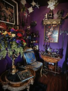 a room filled with lots of different types of flowers and decorations on the wall above it