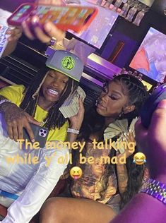 two young women sitting next to each other in front of a bar with the caption'the money talking while all behind them is smiling