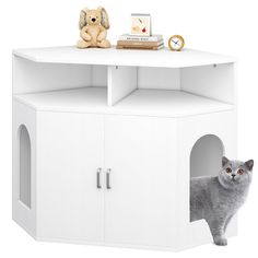 a white cat house with a grey cat in it's hole next to a stuffed animal