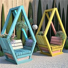 three different colored wooden planters sitting next to each other in front of a fence