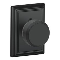 the black push button on an electrical wall plate with a round knob in the center