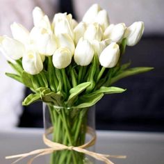 a vase filled with white flowers on top of a table