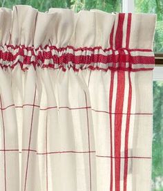 red and white checkered curtains hanging on a window sill in front of a window