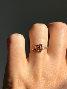 Please no orders to the USA for under $100 CAD due to Canada post strike! No orders outside Canada or the US at this time. Vintage 10k gold ring with a heart design. Has a small ruby centre and one small diamond on the side. Stamped and tested 10k gold. In great condition with minor signs of wear.   Fits US ring size 6  7mm long at the heart 1.5mm wide at the base of the ring 1.27 grams in weight Will be mailed with tracking and in a gift box! 14k Heart Cut Diamond Ring For Valentine's Day, Heart-shaped 14k Gold Ruby Promise Ring, Valentine's Day Birthstone Ring With Diamond Accents, 14k Gold Ruby Ring For Valentine's Anniversary, Gold Heart-shaped 14k Gold Ruby Ring, 14k Gold Heart-shaped Ruby Ring, Gold Heart-shaped Ruby Ring In 14k Gold, Heart-shaped Ruby Ring In 14k Gold, Promise Heart Cut Ruby Ring In 14k Gold