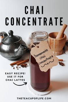 a jar of homemade chai concentrate sitting on top of a table with cinnamons