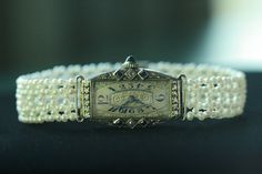 "This antique watch showcases a unique hand-woven seed pearl bracelet. The gorgeous 1.5-2mm pearls are a perfect pairing for everyday and dressy occasions. The Swiss wind-up timepiece is decorated with diamonds and sapphires. 18k white gold watch and 14k gold filigree clasp are from the Art Deco era. Watch is in good working order. THE DETAILS: Length: 7\" (177.8mm) Width: .47\" (12mm) Bead size: .04\" x .08\" (1-2mm) Antique Centerpiece: Solid 18k White Gold Antique Clasp: Solid 14k White Gold White Gold Watch, Baby Gold Rings, Art Deco Watch, Antique Watch, Engagement Ring Photos, Gold Diamond Engagement Rings, White Gold Sapphire, Antique Watches, Gold Filigree