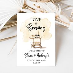 a welcome card with the words love is brewing and an image of a bar cart