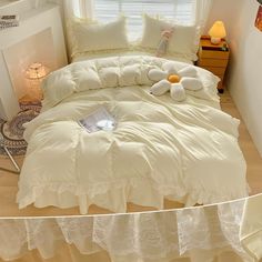 a bed with white comforter and pillows on it