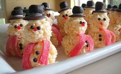 rice krispy kreme snowman treats on a white plate