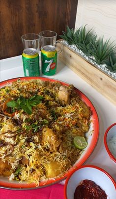 a plate with food on it next to some drinks and condiments in bowls