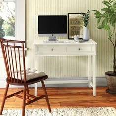 a white desk with a computer on top of it