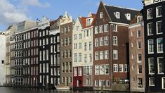 several buildings line the water in front of each other