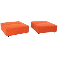 two orange ottomans sitting next to each other