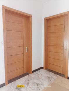 an empty room with two wooden doors in it