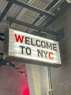 a welcome to nyc sign hanging from the ceiling