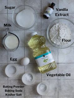 ingredients needed to make an egg muffin recipe laid out on a tile floor with eggs and flour