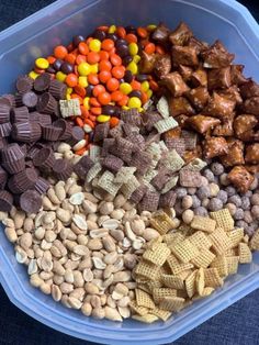 a plastic container filled with lots of different types of candy bars and snacks in it