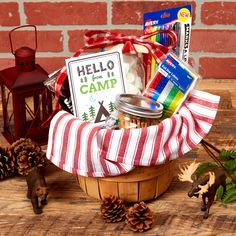 a basket filled with items sitting on top of a wooden table next to a candle