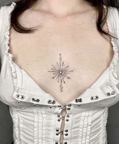 a woman's chest with a star tattoo on her left side and an arrow in the middle