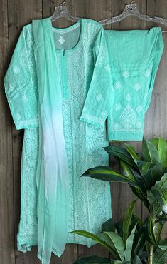 Comfy all day wear ! Cotton hand embroidered Chikankari Kurta and lined pants with shaded chiffon Dupatta.    Matching liner included. Kurti length: 46 inches  Bottom length: 38 inches  Elastic waistband Green Chikankari Embroidered Palazzo Set For Summer, Green Mulmul Palazzo Set With Chikankari Embroidery, Green Cotton Sharara With Floral Embroidery, Green Mulmul Sharara With Chikankari Embroidery, Green Sharara With Chikankari Embroidery In Mulmul, Summer Pista Green Palazzo Set With Chikankari Embroidery, Pista Green Chikankari Embroidered Palazzo Set In Mulmul, Spring Anarkali Set With Cutwork, Bohemian Pista Green Kurta With Chikankari Embroidery