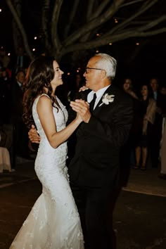 an older man and woman dance together at their wedding