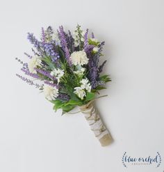 a bouquet of flowers sitting on top of a white wall