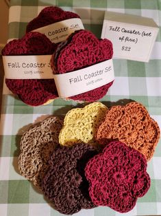 several crocheted coasters on a table with price tags in the middle and below them