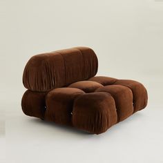 a brown reclining chair sitting on top of a white floor