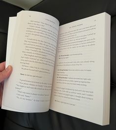 a person is holding an open book in their hand