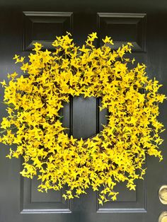 a yellow wreath is hanging on the front door