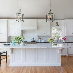 an image of a white kitchen with lots of counter space and decor on the front page