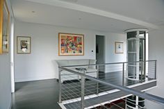 a living room filled with furniture and a metal hand rail in front of a doorway