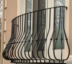 an iron balcony railing on the outside of a house