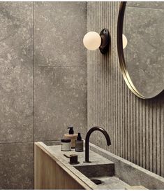 a bathroom sink sitting under a mirror next to a faucet and soap dispenser