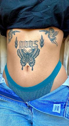 a woman with a butterfly tattoo on her stomach