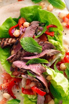 a close up of a plate of food with meat and veggies on it