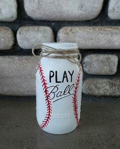 a baseball canister sitting on top of a counter next to a pile of rocks