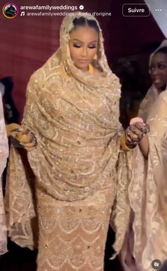 the woman is dressed in an elaborate gold dress and shawl, with her hands on her hips