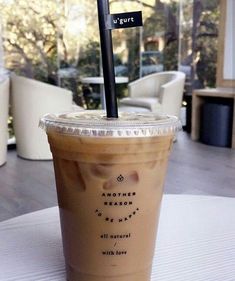 a drink sitting on top of a table with a straw in it's cup