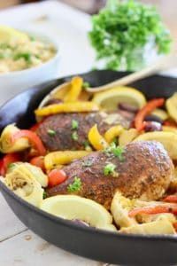 a pan filled with meat and vegetables on top of a table