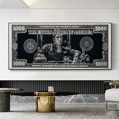 a dollar bill is hanging on the wall above a table in a room with chairs