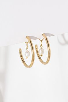 Just another pair of hoop earrings? Think again! Liz Hoop Earrings are a  showstopper!  Made of gold or silver plated brass, according to your choice, and decorated with a delicate chain and a freshwater pearl pendant. The plating on this item is nickel-free, which means it is great for sensitive skin as well. The jewelry will arrive in our branded packaging. We can attach a personal note upon request.  Diameter: 2.5 cm / 1" All images are the property of Shlomit Ofir Jewelry Design. Mystic Eye, Earrings Classic, Think Again, Earrings Pearl, Delicate Chain, Schmuck Design, Jewelry Earrings Hoops, Silver Hoop Earrings, Bridal Earrings