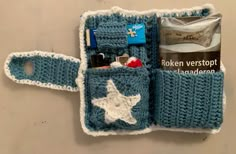 a crocheted blue and white case with items in it