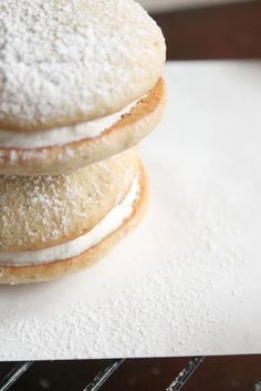 three powdered donuts stacked on top of each other with icing and sugar