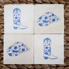 four blue and white tiles with cowboy boots on them